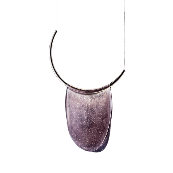 An Italamp Dali pendant necklace with a curved shape hanging on a black background.