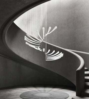 A modern building staircase featuring a stunning Italamp Pulsa Spira chandelier for illumination.
