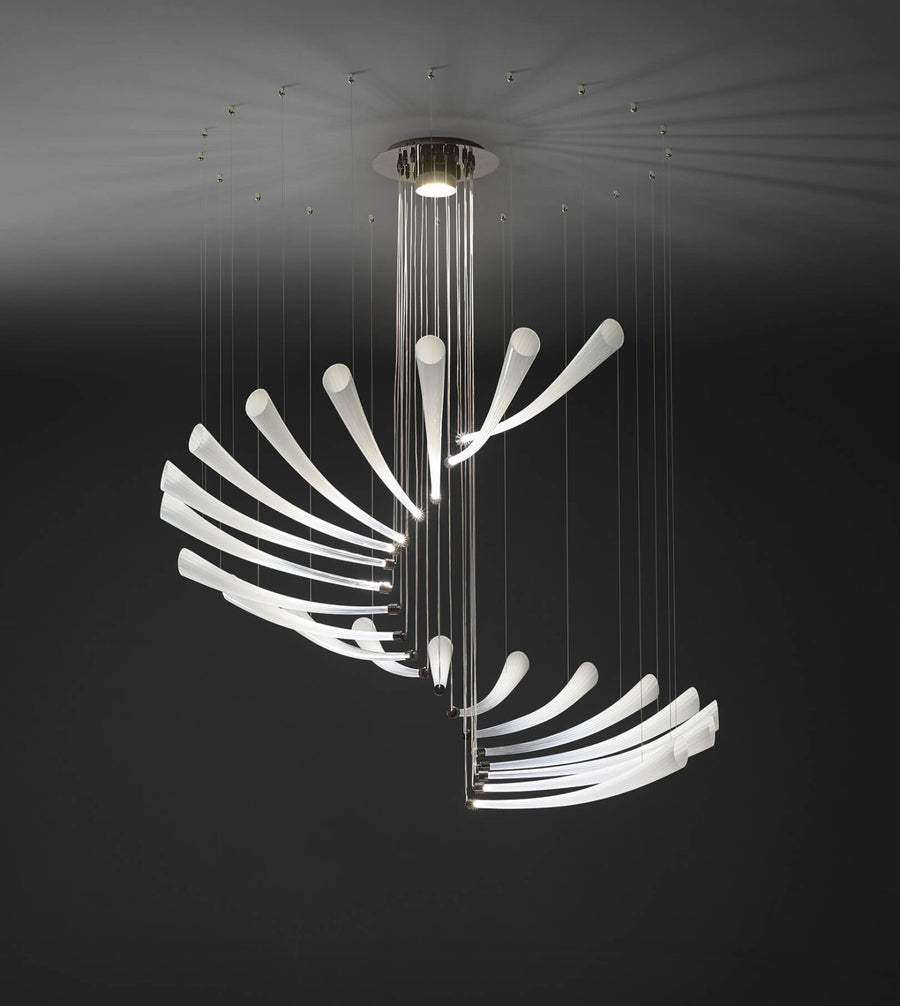 An Italamp Pulsa Spira, a contemporary chandelier providing illumination, crafted with blown glass, is suspended from the ceiling.