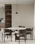 A modern dining room with a dining table and chairs illuminated by the Italamp Regolo Suspension Light, showcasing a blend of contemporary lighting and modern elegance.