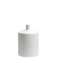 A minimalist white ceramic vase with a cylindrical body and a short, angled neck, shown on a seamless white background.