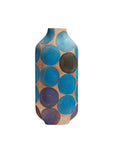 A tall, narrow ceramic vase with a rounded shoulder and flared base, decorated with a pattern of overlapping hand-painted circles in shades of blue, purple, and dark brown on a warm beige background.