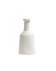 A minimalist white ceramic vase with a wide, tapered body and a short cylindrical neck, shown against a solid white background.