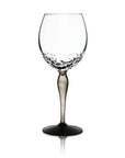 A clear glass wine glass with a textured, dimpled pattern around the base and a slender stem, shown on a plain white background with a soft reflection below.