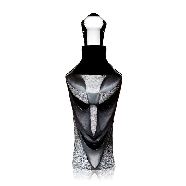 A face shaped crystal decanter on a gray background from Maleras, available at Spacio in India. 