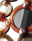 Decorative Murano wall mirror with circular, amber-colored frames on a dark background