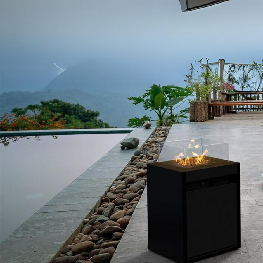 Planika's Square Gas fireplace in an outdoor setting beside a swimming pool in a hill home. 