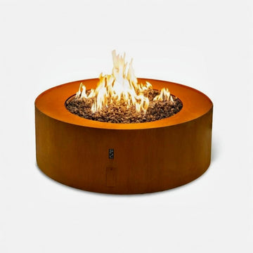Galio Corten Round gas outdoor  fireplace with flames on a white background from Planika, available at Spacio retail stores in Mumbai & Kolkata. 