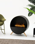 Modern artificial water vapour fireplace with flames, green chair, and plant on a white background available at Spacio retail stores in India. 