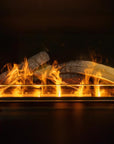 Artificial water vapour fireplace with burning logs and flames on a dark background available at Spacio retail stores in India. 
