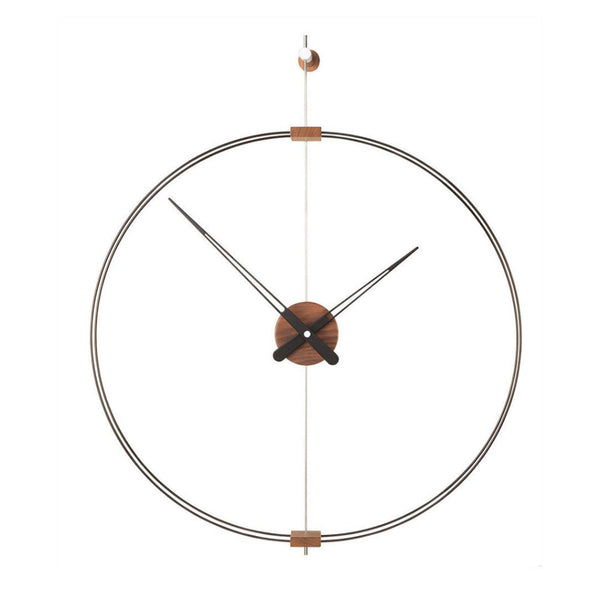 A Nomon Barcelona Mini MBAR wall clock with a circular shape hanging on a wall, featuring an elegant and sophisticated design.