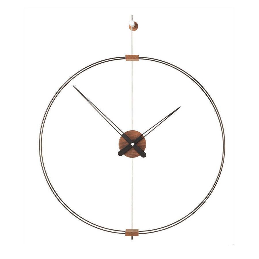 A Nomon Barcelona Mini MBAR wall clock with a circular shape hanging on a wall, featuring an elegant and sophisticated design.