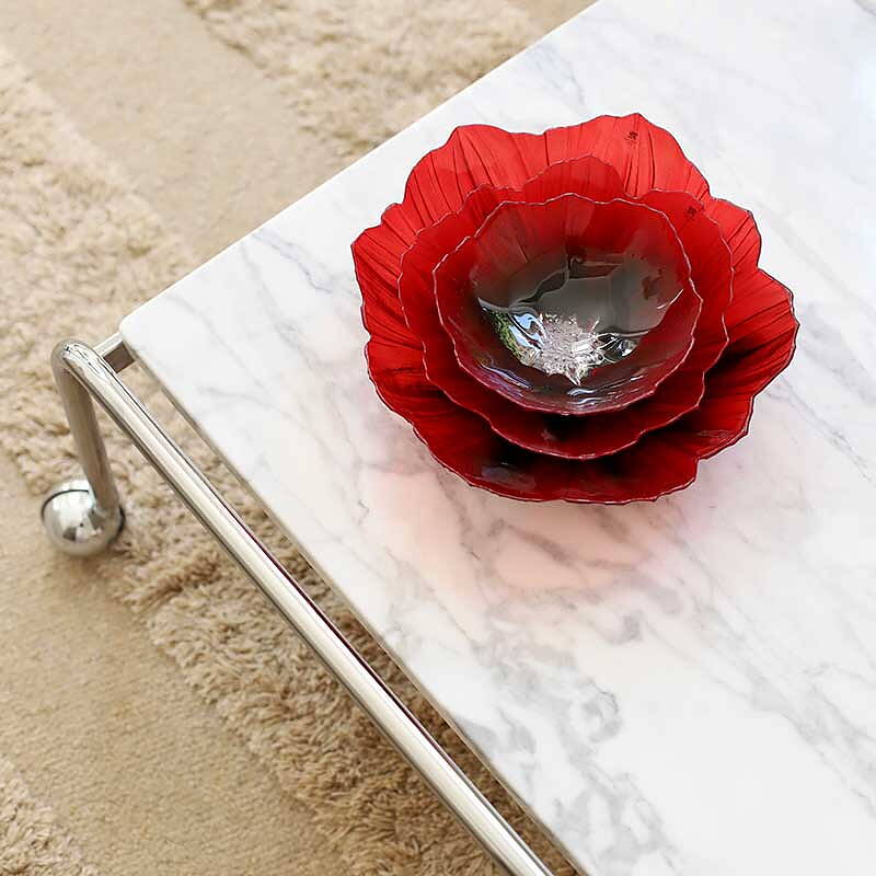 Maleras Crystal Poppy Red Black Medium Bowl with other sizes bowls on marble coffee table in modern interiors available at Spacio India from Decor Accessories and Tableware Collection of Decorative Bowls.