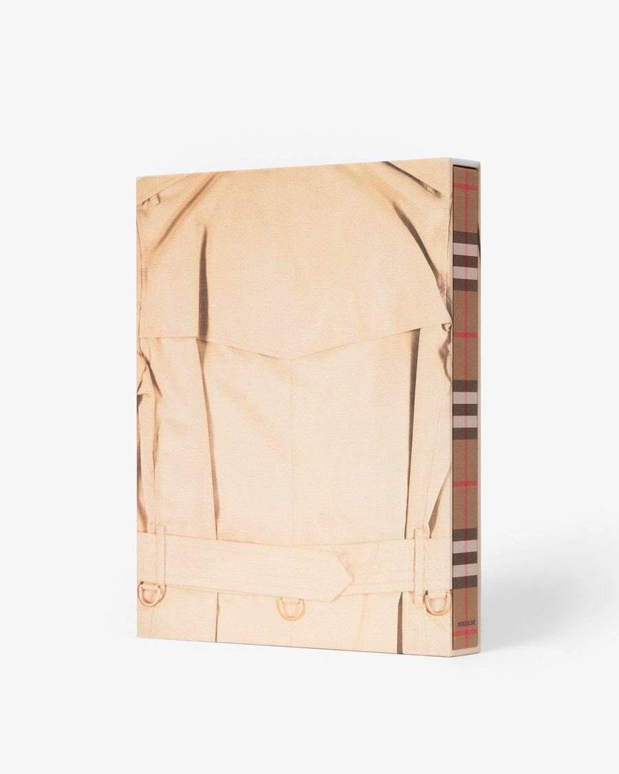 Back slip cover in linen. Burberry coffee table book by Assouline, celebrating 165 years of British style, iconic trench coats, and timeless luxury through stunning illustrations and stories.