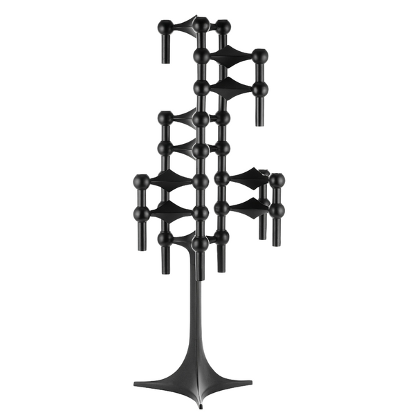 A black metal wall-mounted candelabra  with a sculptural, geometric design featuring spherical and cylindrical elements on a solid white background.