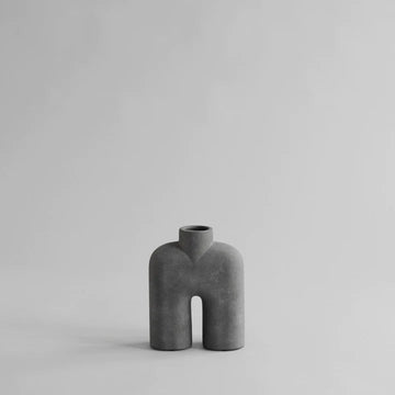 A small grey 101Cph Cobra Tall Mini Dark Grey 211034 vase sitting on a white surface.