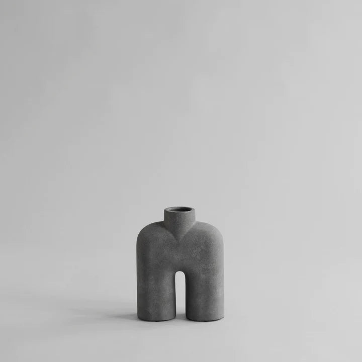 A small grey 101Cph Cobra Tall Mini Dark Grey 211034 vase sitting on a white surface.