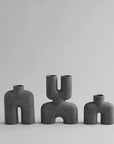 Three 101Cph Cobra Tall Mini Dark Grey 211034 vases by 101 Copenhagen on a white background.