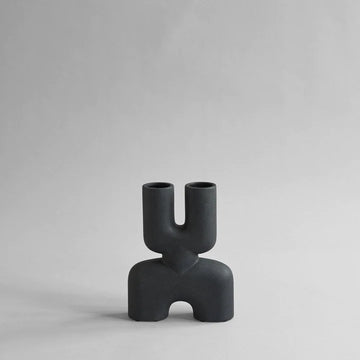 A quirky 101Cph Cobra Double Mini Black 203025 vase by 101 Copenhagen stands out against a white background.