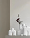 Three 101Cph Cobra Double Mini Bubble White 203022 vases, inspired by Copenhagen design, sit on a shelf in a room.