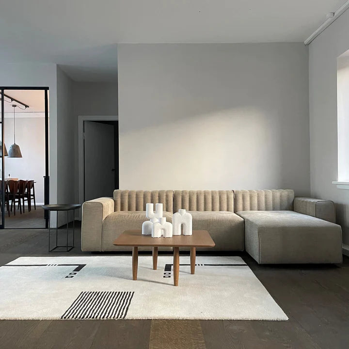 A living room with a 101Cph Cobra Double Mini Bubble White 203022 couch from 101 Copenhagen and a white coffee table.