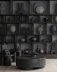 A room decorated with the Cobra Arts Movement showcasing 101 Copenhagen Guggenheim Mini Dark Grey 203005 Vases on shelves.