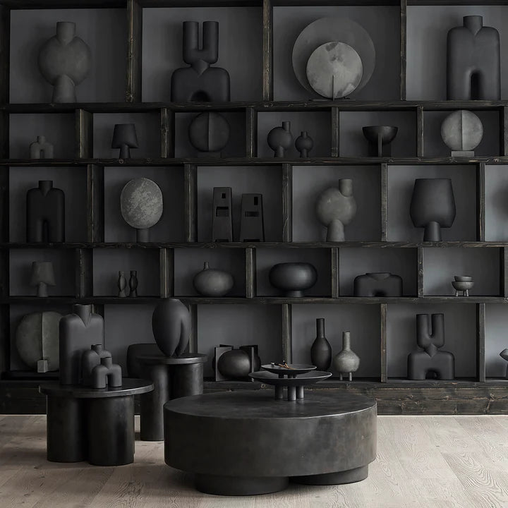 A room decorated with the Cobra Arts Movement showcasing 101 Copenhagen Guggenheim Mini Dark Grey 203005 Vases on shelves.