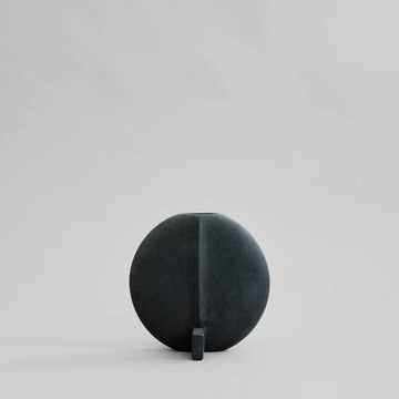 A quirky 101Cph Guggenheim Petit Black 213042 by 101 Copenhagen sitting on a white surface.
