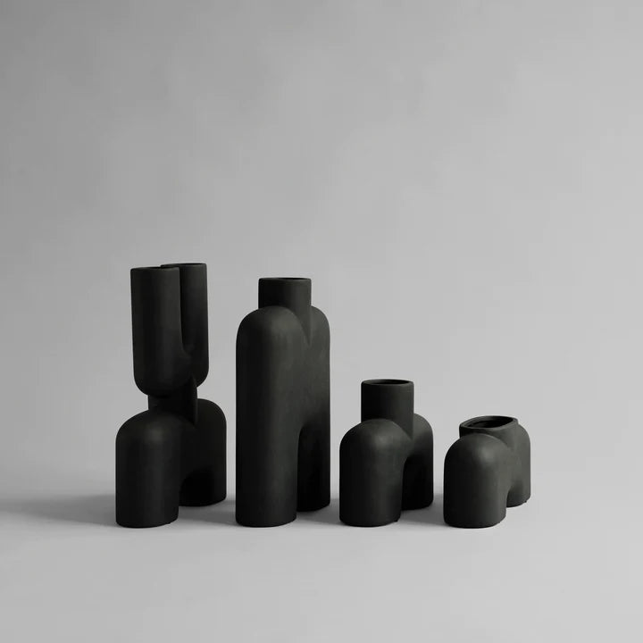 A collection of black vases, including the 101Cph Cobra Double Medio Black 212006 vase by 101 Copenhagen, showcased against a pristine white background.