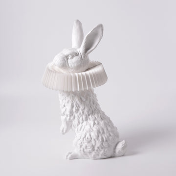 A Haoshi Rabbit Stand Lamp with a hat on its head shines as an LED light, creating a warm atmosphere.