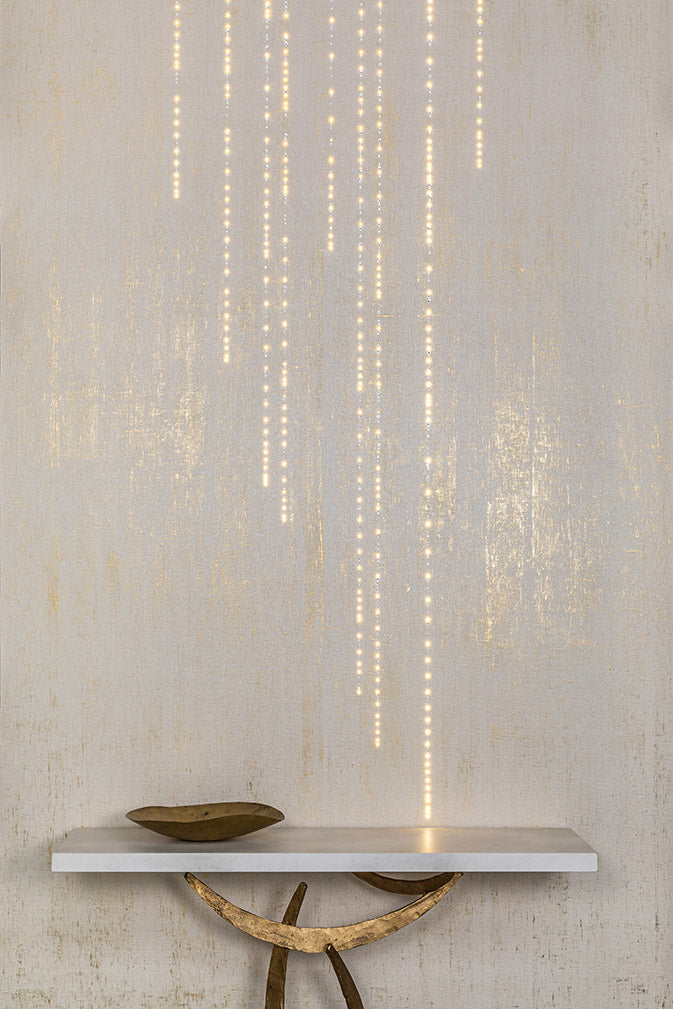 A table with Conductivity LED Wallpaper with Swarovski by Meystyle on top of it that illuminate through conductivity.