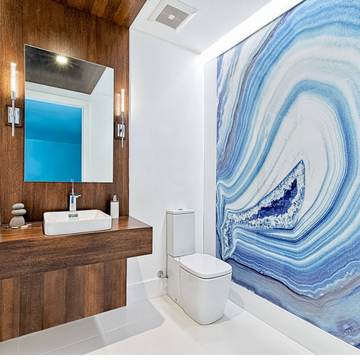 A bathroom with a stunning Alex Turco Mineral Blue Agate wall mural, showcasing exquisite interior design and using water resistant epoxy resins.