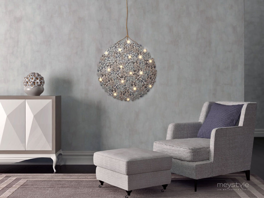 A modern living room with a large Meystyle pendant light featuring ambient lighting, the Germanium LED Wall Paper with Swarovski.